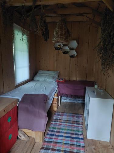 a bedroom with a bed and a table in a cabin at Api terapia Bojnice in Bojnice