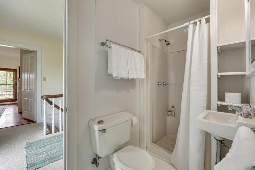 a white bathroom with a toilet and a sink at Waterfront Home with Large Yard, Dock & Bay View in Heathsville