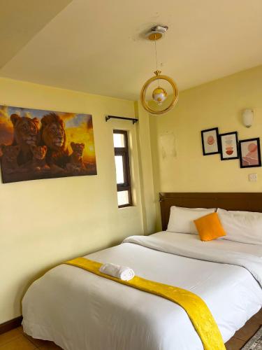 a bedroom with two beds and a painting on the wall at Pendo suite in Nairobi