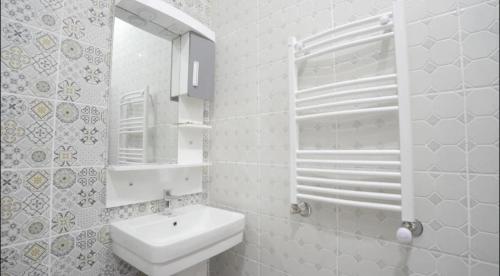 a white bathroom with a sink and a mirror at Marhaba Hotel Casbah in Kasbah