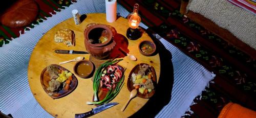 a wooden table with plates of food on it at Ivovik in Rožaje