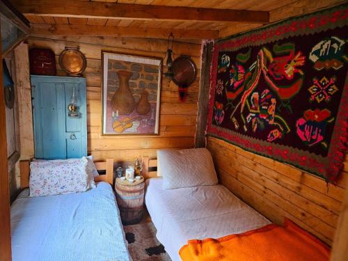 a room with two beds in a log cabin at Ivovik in Rožaje