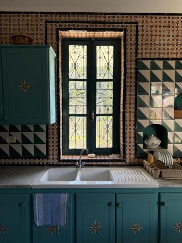 a kitchen with a sink and a window at Darelkhir in Tazarka
