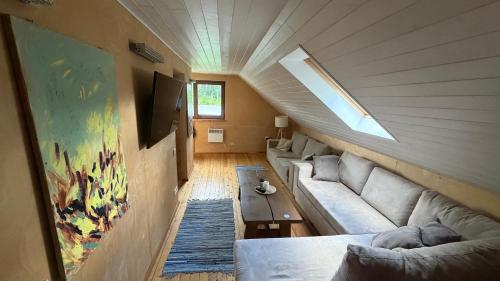 a living room with a couch and a table at Möllatsi Saunamaja in Möllatsi