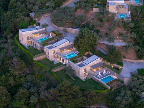 an aerial view of a mansion with two swimming pools at Atrium Villas in Kechria