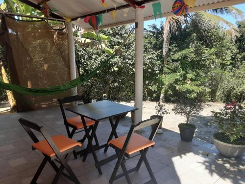 a table and chairs sitting on a patio at Abelha & Peixe Boi in Santo Amaro