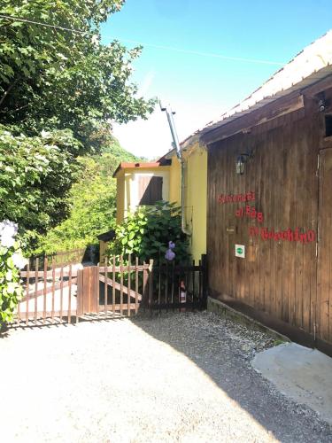 a house with a wooden fence next to a driveway at Bed and breakfast Al Turchino in Mele