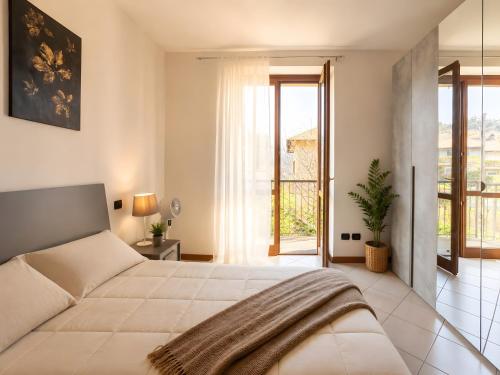 a bedroom with a large bed and a balcony at La Terrazza delle Colline in Brunello