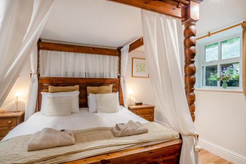 a bedroom with a canopy bed with two pillows at 2 Bed in Hexham oc-88032 in Bardon Mill