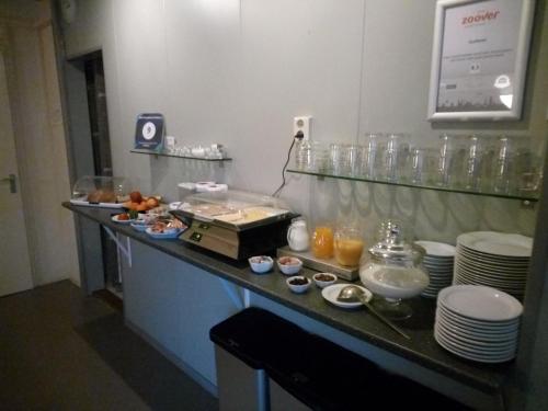 a breakfast buffet in a hotel room with food at Bed & Breakfast Zuidlaren in Zuidlaren
