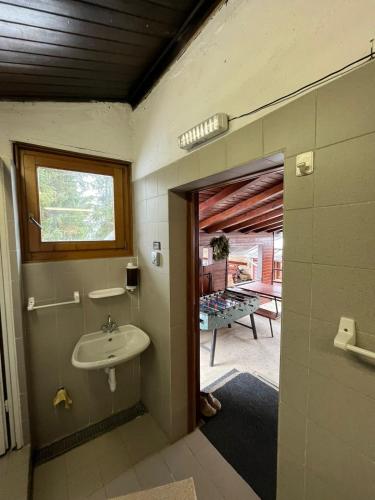 a bathroom with a sink and a view of a patio at Baita Pòz in Valfurva