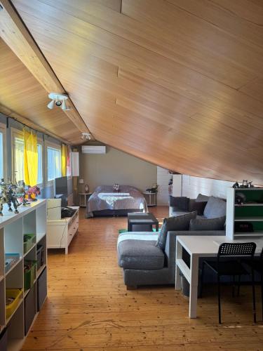a living room with a couch and a table at Villa Aurora in Rovaniemi