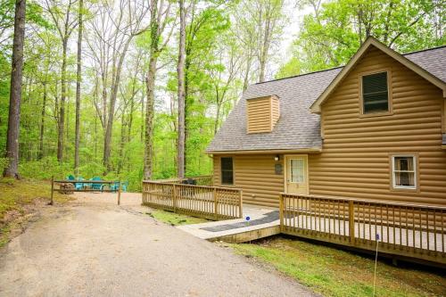 a log cabin with a porch and a picnic table at Tree-Top Chalet in Logan