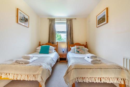 two twin beds in a room with a window at 3 Bed in Hawes oc-ds967 in Hawes