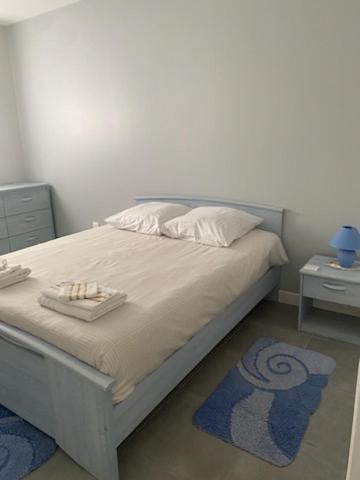 a bedroom with a bed with two towels on it at Era in Chancelade