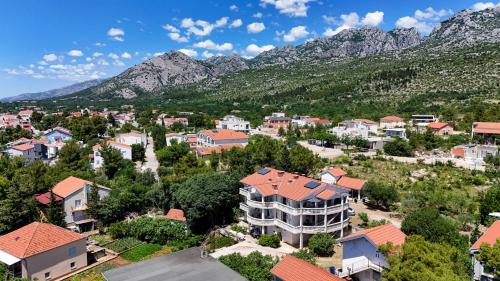 an aerial view of a town with mountains in the background at Vila Velebita in Seline