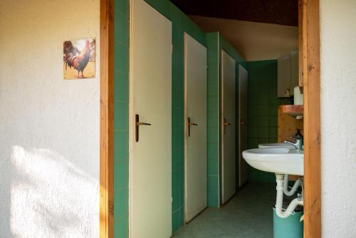 a bathroom with a white sink and green walls at Bikers camp in Poreč