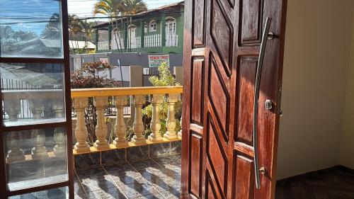a door to a store with vases on a balcony at Casa confort - Vicente pires in Brasília