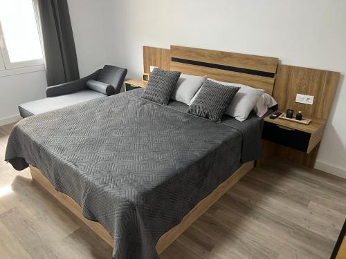 a bedroom with a large bed and a chair at Apartment in Amer in Amer