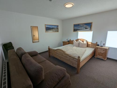a living room with a bed and a couch at Appart Gfall in Ried im Oberinntal