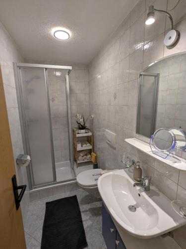 a bathroom with a shower and a sink and a toilet at Appart Gfall in Ried im Oberinntal