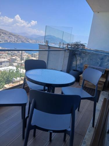 a table and chairs on a balcony with a view at Denis Apartments in Sarandë