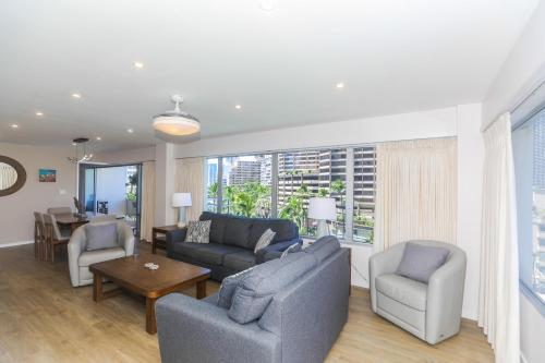 a living room with a couch and chairs and a table at Ilikai Tower 525 in Honolulu