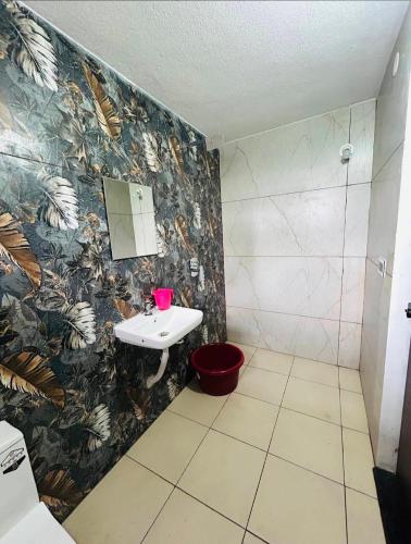a bathroom with a toilet and a sink and a mirror at Greenview Homestay in Sakleshpur
