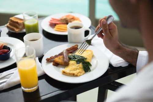 a person is eating breakfast on a table at Seadust Cancun Beach Resort - All Inclusive in Cancún