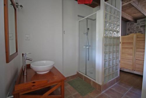 a bathroom with a sink and a glass shower at Lascaux in Saint-Mathieu