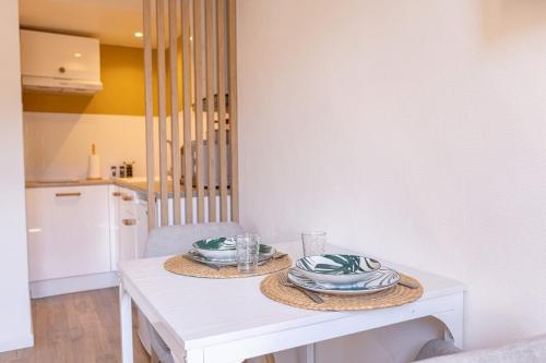 a white table with two plates on top of it at Suite du Soleil - Studio - Hypercentre in Narbonne