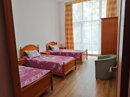 a room with three beds and a window at Вилла Витязь in Chok-Tal
