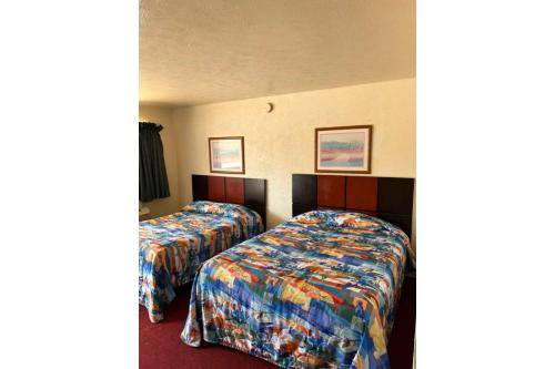 a room with two beds in a hotel room at Desert Sands Denton near UNT I 35 TX in Denton