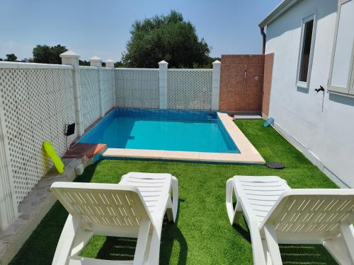 a small swimming pool with two chairs and a pool at DolceApulia Country House in Conversano
