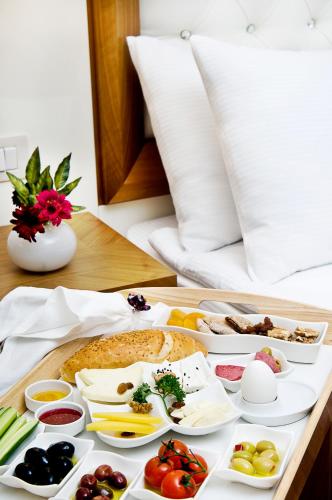 a tray of food with eggs and vegetables on a table at Tugcu Hotel Select in Bursa