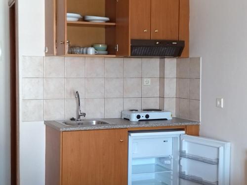a kitchen with a sink and a counter top at Iris by Dias in Olympic Beach