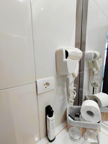 a bathroom with two hair dryers and a mirror at DENY INN Funland in Zărneşti