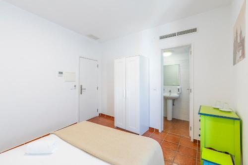 a small room with a bed and a sink at HI Évora – Pousada de Juventude in Évora