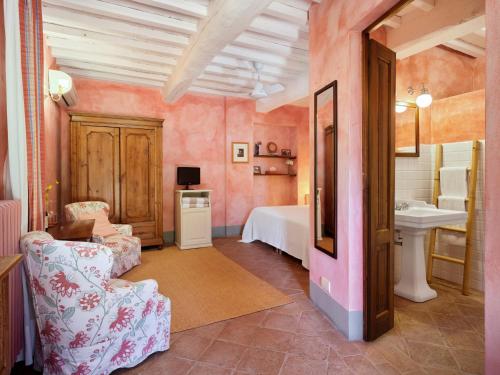 a bedroom with a bed and a sink and a bathroom at La Locanda Volpaia in Radda in Chianti
