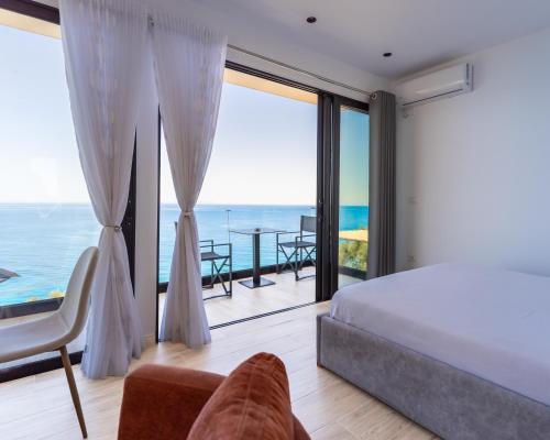 a bedroom with a bed and a view of the ocean at Oceanfront Oasis in Borsh