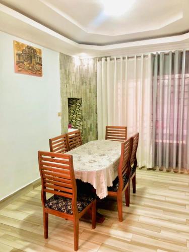 a dining room with a table and chairs at Gravity Villa Musanze in Ruhengeri