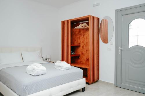 a bedroom with a bed with towels on top of it at LV Luxury Apartment in Parga