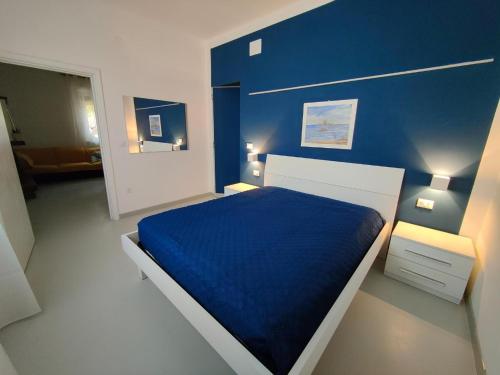 a blue bedroom with a bed with a blue wall at Contry House Atessa in Atessa