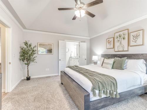 a bedroom with a bed and a ceiling fan at Kingsport Modern Oasis in Broken Arrow