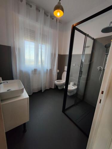 a bathroom with a mirror and a sink and a toilet at Contry House Atessa in Atessa