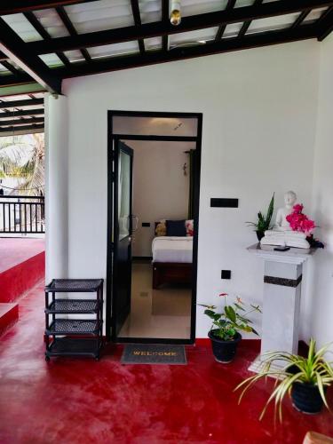 a room with a mirror and a room with a bed at S & B Villa Weligama in Weligama