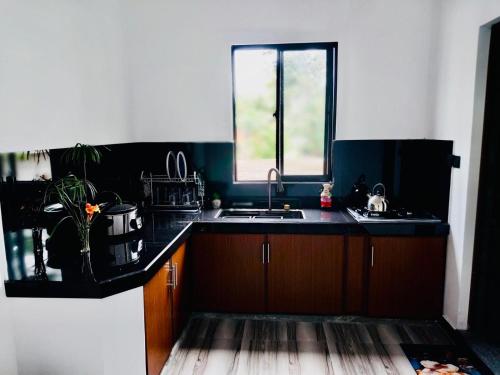 a kitchen with a sink and a window at S & B Villa Weligama in Weligama