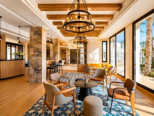 a lobby of a hotel with chairs and tables at Le Corail Apart'Hotel & Splash Park in Hammamet