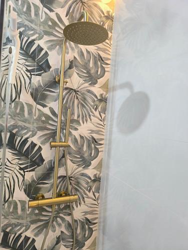 a bathroom with a wall with a plant wallpaper at Casa Torrox Costa cerca del mar in Torrox