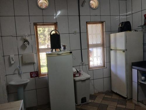 a kitchen with a refrigerator and a sink at sitio Ibiúna in Ibiúna
